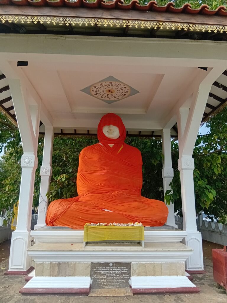 Orange-covered Buddha statue in Tissamaharama, Sri Lanka