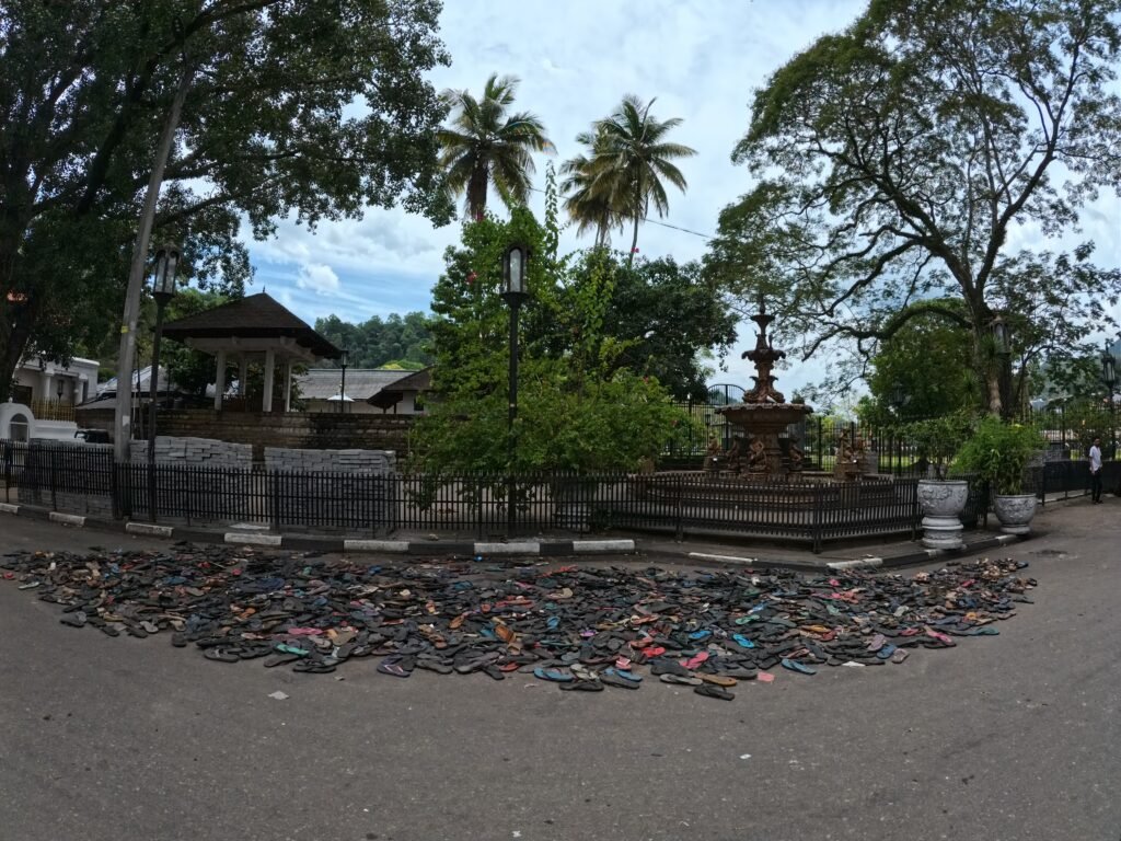 the flip-flops left outside after the festivities. Hundreds of flip-flops left outside the Temple of the Sacred Tooth in Kandy